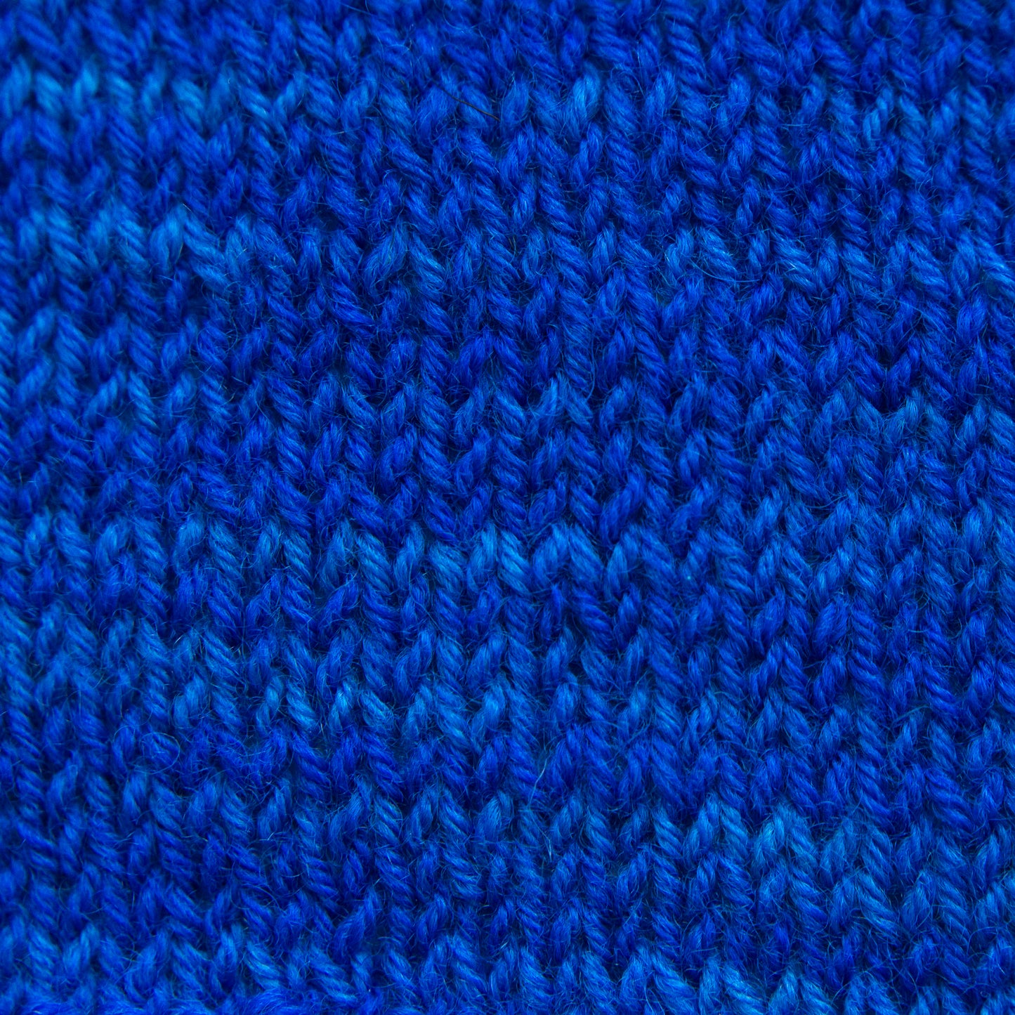 A close-up of a vibrant blue knitted fabric.