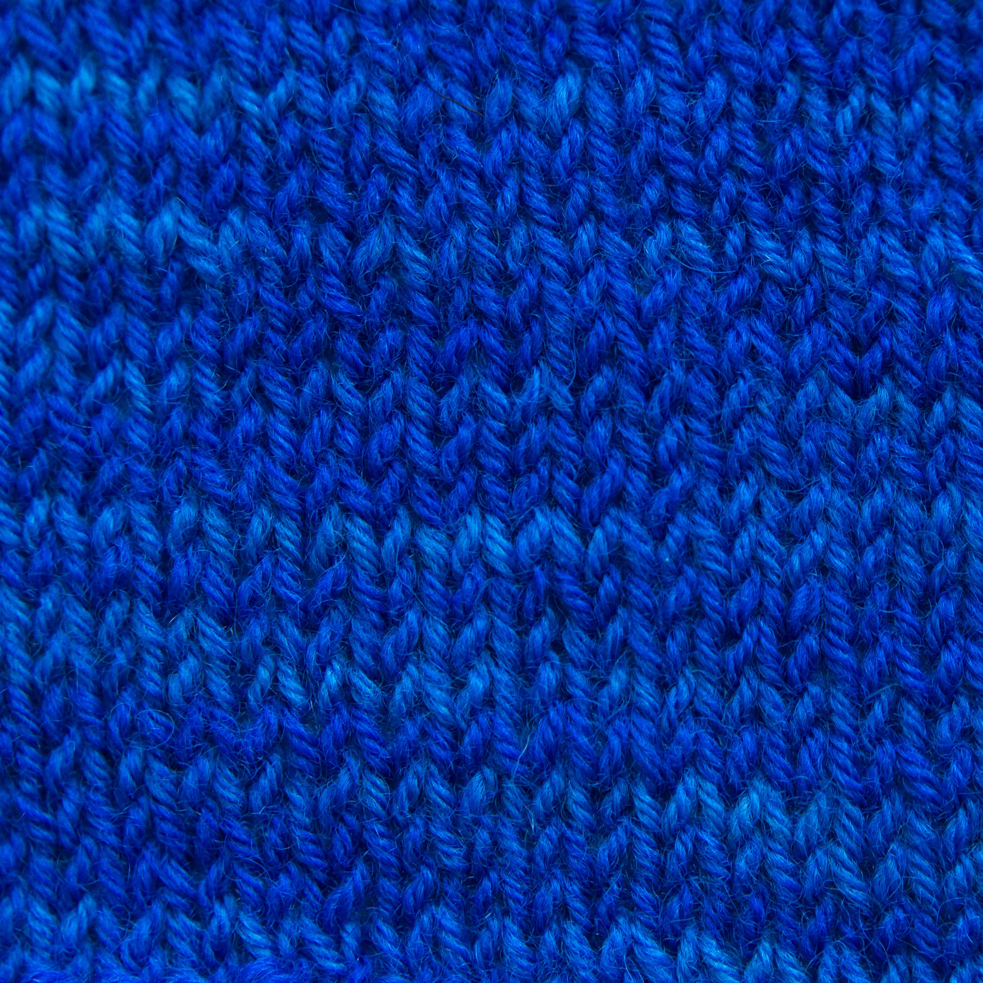 A close-up of a vibrant blue knitted fabric.